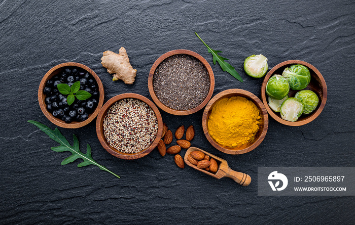 Super foods on in wooden bowl. Selection food and healthy food set up on dark stone background.