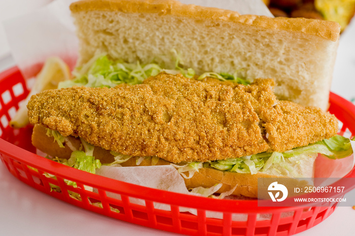 Fried fish or po boy sandwich. Classic Cajun cuisine: fried fish sandwich served on toasted bun w/on