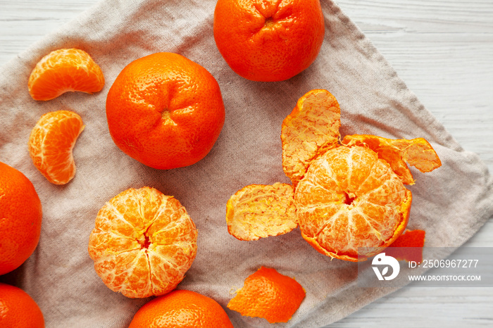 Raw Organic Mandarin Oranges on a white wooden table, top view. Flat lay, overhead, from above. 