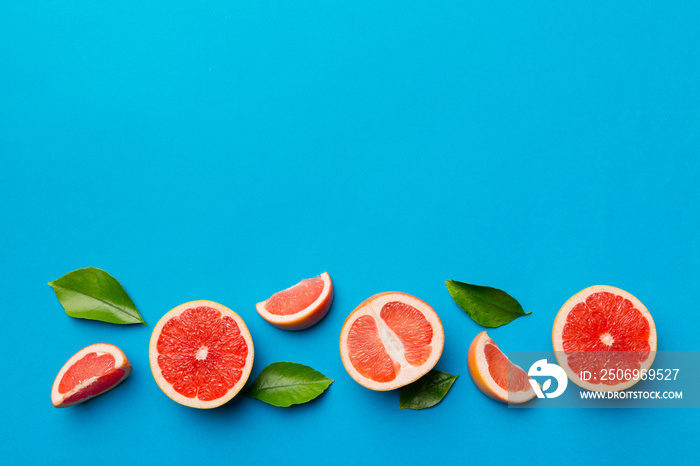 fresh Fruit grapefruit with Juicy grapefruit slices on colored background. Top view. Copy Space. cre