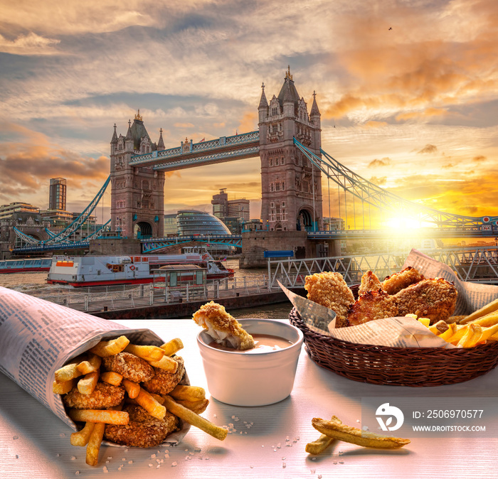 Tower Bridge against fish and chips served on the table in London, United Kingdom