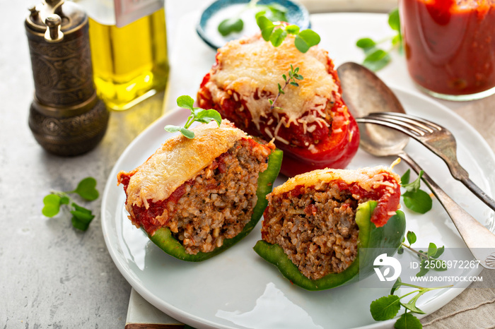 Stuffed peppers with ground beef filling on a plate