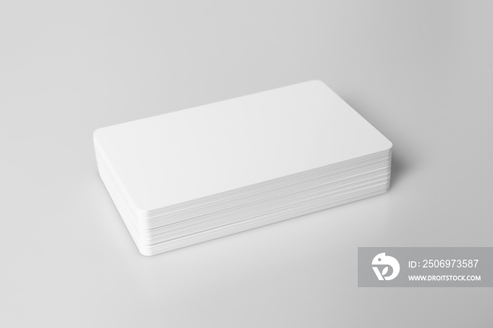 Stack of  white blank credit cards mockup on white background.