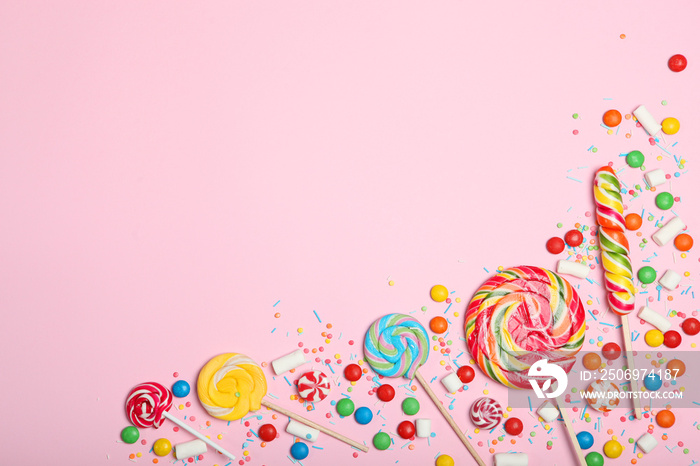 Candies and sweets on a colored background top view with place for text.