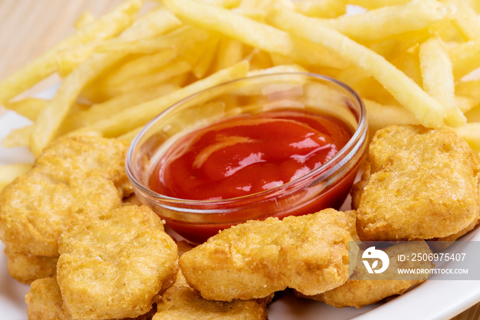 Delicious Chicken nuggets and french fries with ketchup