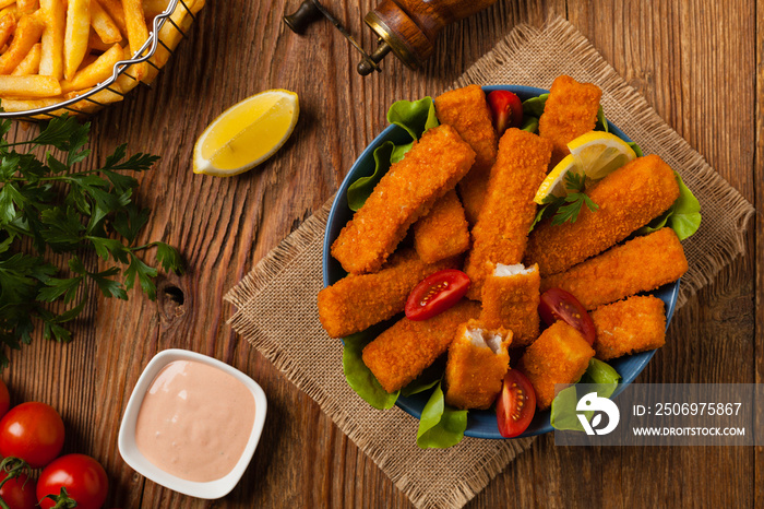 Fish sticks with salad in blue bowl.