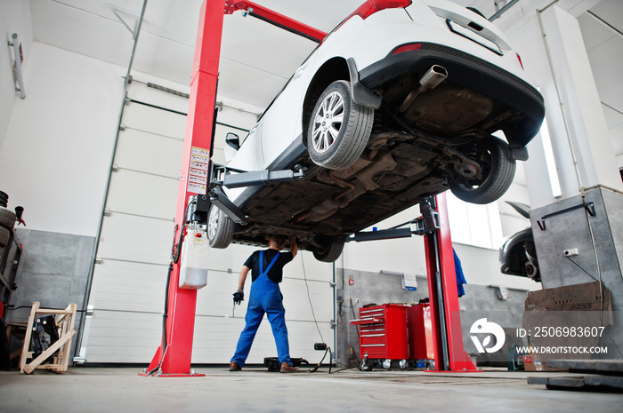 Car repair and maintenance theme. Mechanic in uniform working in auto service.