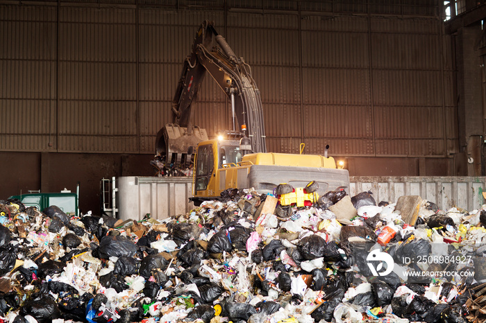 Forklift gathering garbage at recycling plant