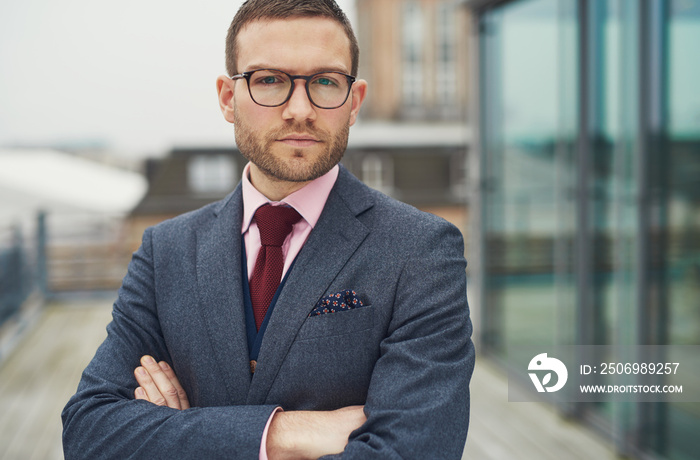 Confident businessman standing outside office