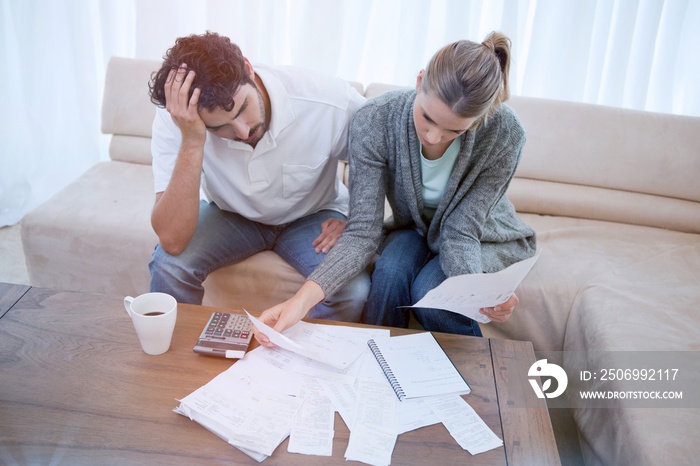 Depressed couple doing their accounting