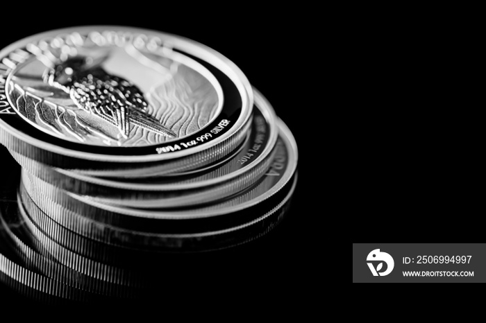 Close up of  Silver Bullion Coin on a black mirror background