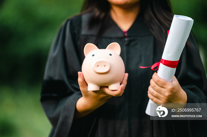 graduates holding piggy banks saving concept