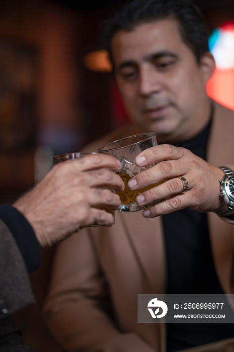 Men raising toast with drinks