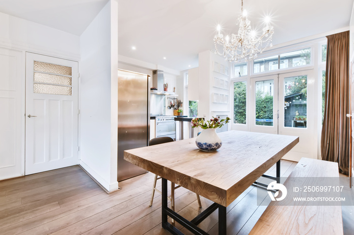 Charming dining room with a solid table and a crystal chandelier