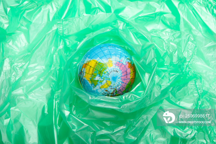 Pollution .Plastic free. Eco concept. Globe wrapped in a plastic bag. Save the planet. Minimalism