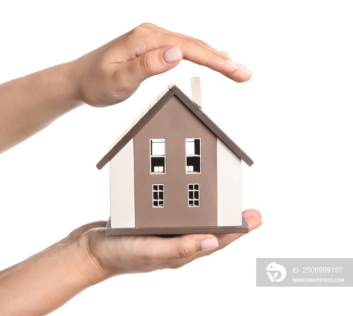 Female hands with figure of house on white background. Mortgage concept