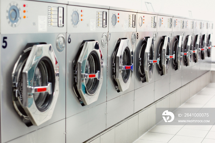 A row of industrial washing machines