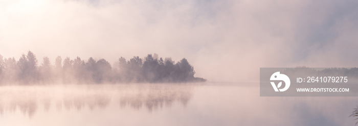 美丽的雾蒙蒙的早晨。日出时分，雾笼罩着秋湖。广泛的全景。