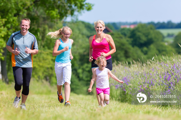 Family sport running through field