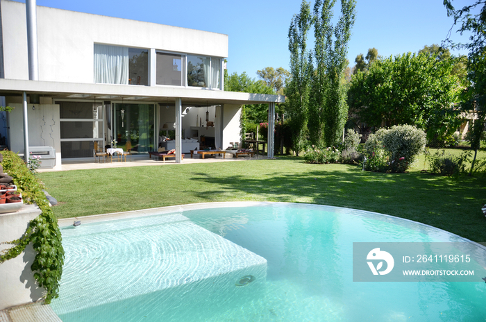 Swimming pool in front of house