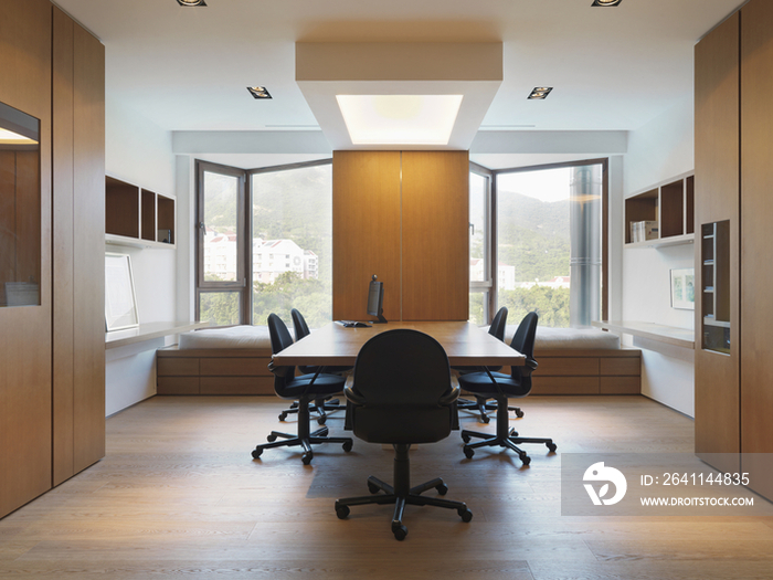 Rolling chairs around wooden table in contemporary conference room; Scottsdale; USA