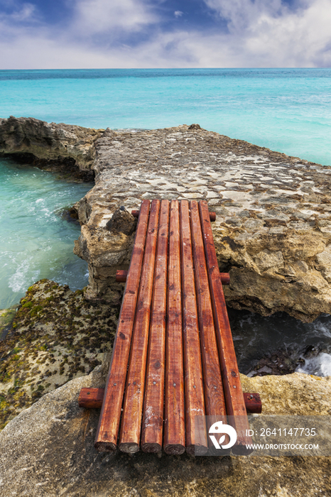 Wooden bridge across rocks on the coastline 