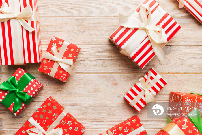 A lot of Christmas gift boxes in colored paper decorated on table, Top view close up. Many present N