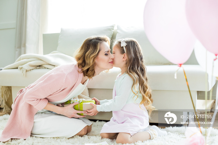 Girl presenting gift to mother