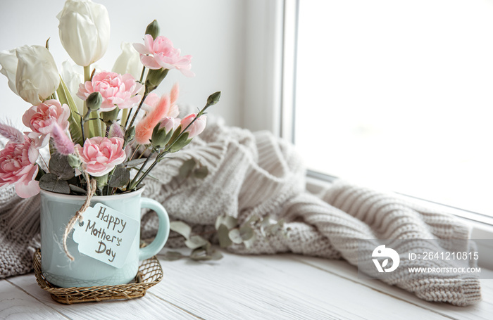 Festive flower arrangement for mothers day with fresh flowers and knitted element copy space.