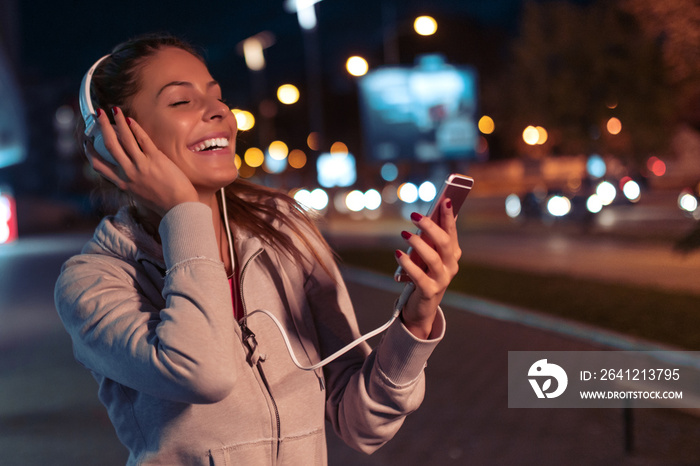 Woman running at night in the city