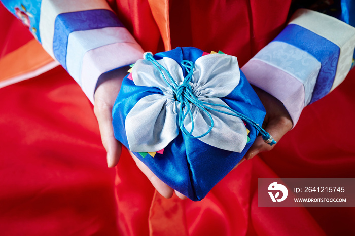 Traditional gift held by a woman in hanbok