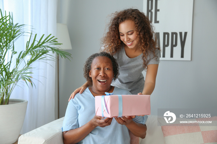 Portrait of African-American woman greeting her mother at home