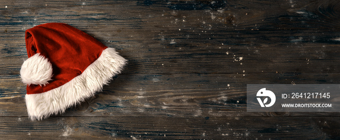 Flat lay of Santas hat on wooden background