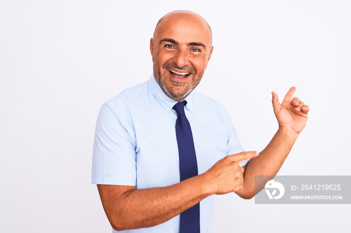 Middle age businessman wearing tie standing over isolated white background amazed and smiling to the