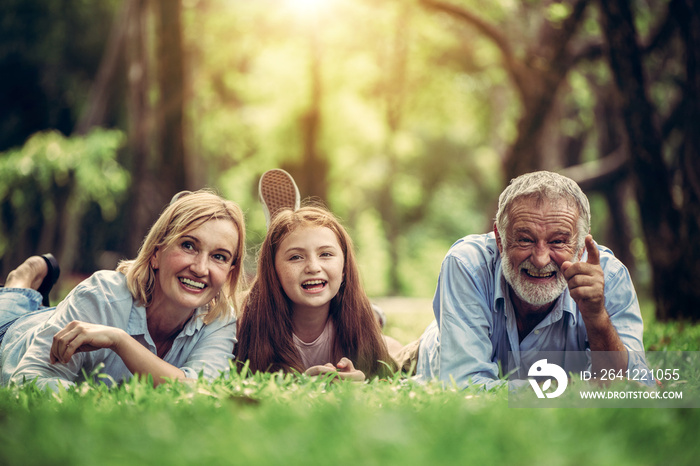 Happy family relaxing together in the park in summer. Concept of family bonding and relationship.