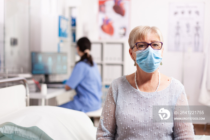 Sick elderly patient woman waiting diagnosis from doctor during treatment wearing face mask. Global 