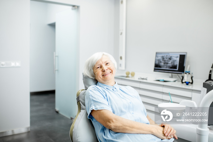 Portrait of a beautiful senior woman with healthy smile sitting at the dental office