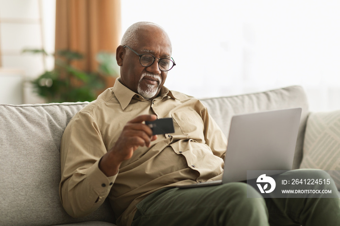 Senior African American Man Shopping Online Using Laptop At Home