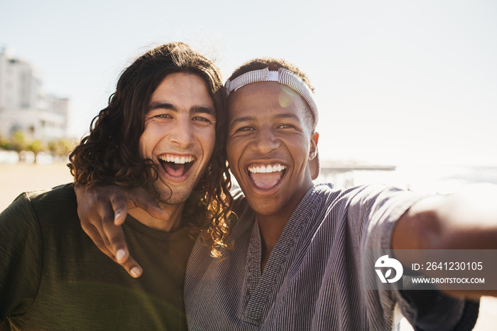 Cheerful friends making a selfie outdoors