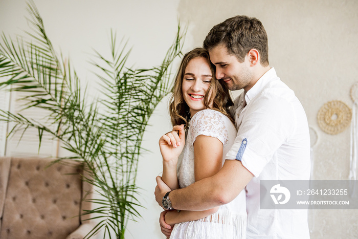 Lovers hug each other in the large bedroom. Love story.