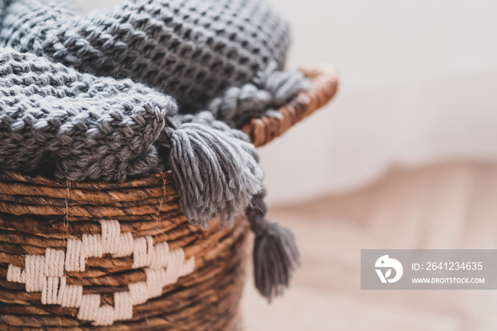 Wicker basket with warm woolen blanket