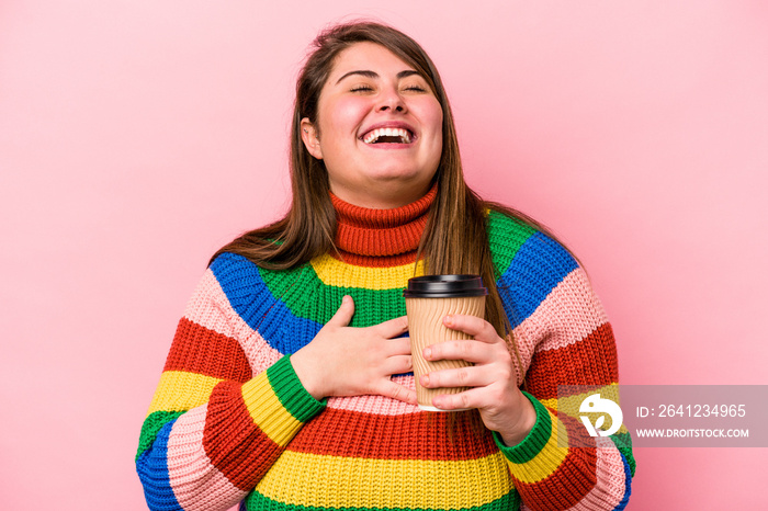 Young caucasian overweight woman holding takeaway coffee isolated on pink background laughs out loud