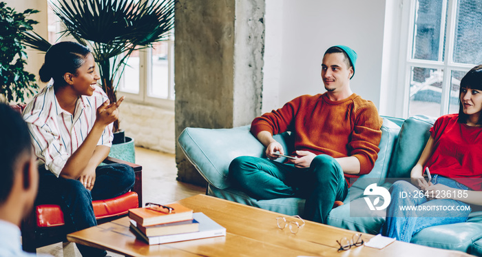 Pleasant black woman talking to man pointing with hand in meeting