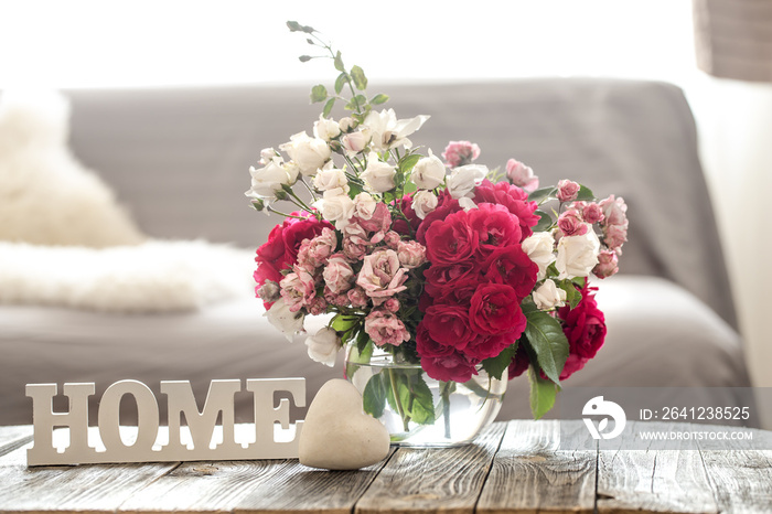 Still life with an inscription home and a vase of flowers