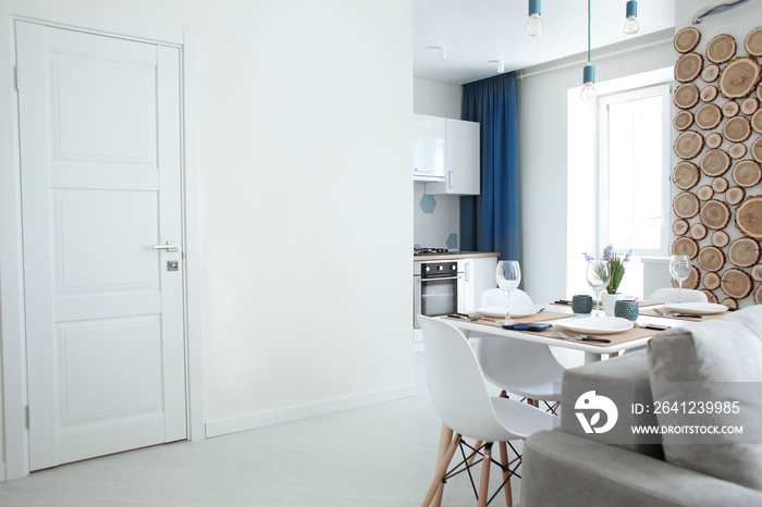 Interior of modern apartment with served table in light room