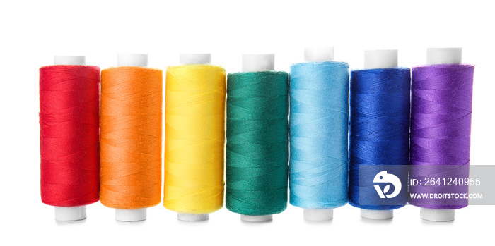 Colorful sewing threads on white background