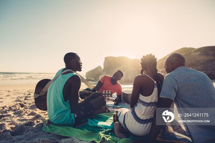 Group of four people having great time at the beach