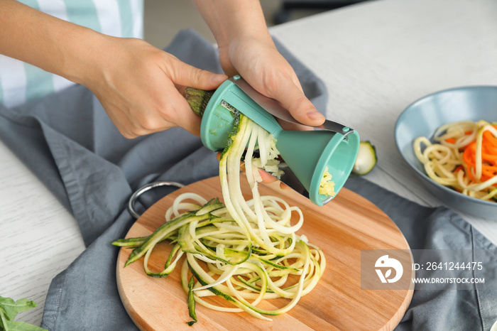 Woman making zucchini spaghetti