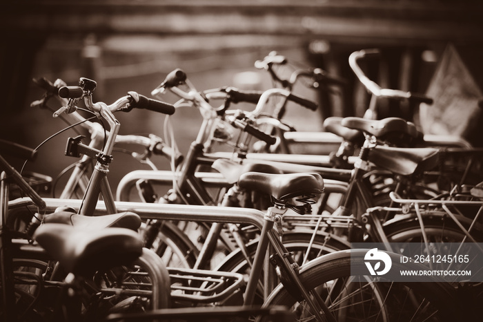 a lot of bikes on parking in Amsterdam, Netherlands . Image in sepia color style