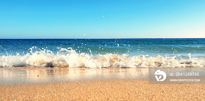 Waves crashing down on the beach in Porto de Mós, Lagos, Portugal 